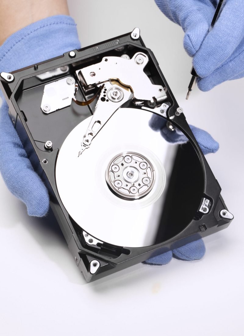 hands-repairing-hard-drive-high-angle
